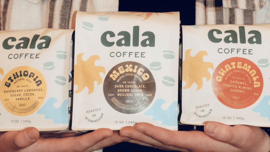 Three bags of Cala Coffee featuring specialty roasts from Ethiopia, Mexico, and Guatemala, held by a person in Birmingham, AL.