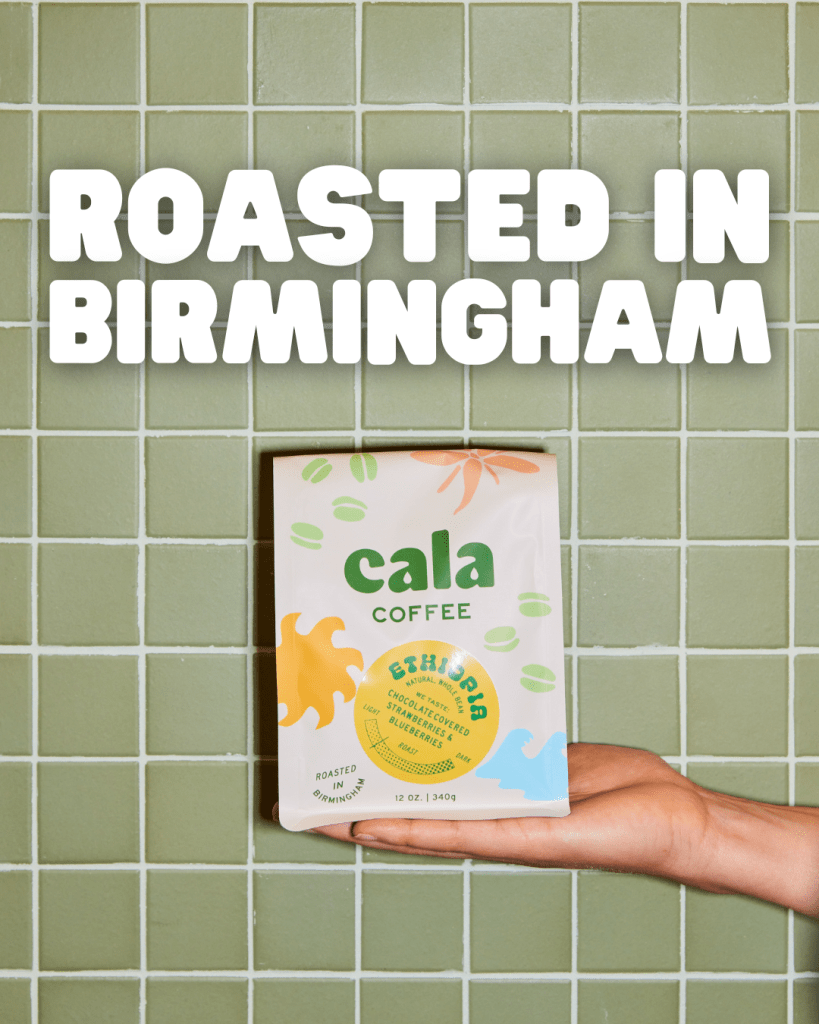 A hand holding a bag of Cala Coffee Ethiopia roast in front of a green tiled background, with bold text stating "Roasted in Birmingham."