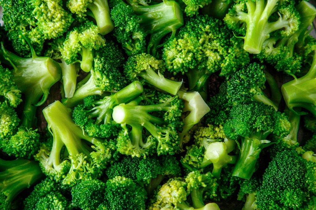 A close-up of fresh steamed broccoli florets with vibrant green color and tender texture.