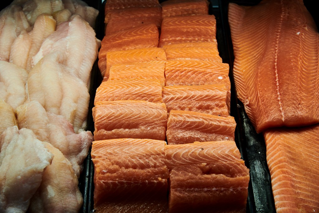 Close-up of fresh salmon fillets and white fish fillets on display in the seafood department at Piggly Wiggly Birmingham