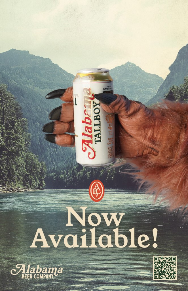 Bigfoot hand holding an Alabama Tallboy beer can in front of a scenic mountain lake with text reading Now Available