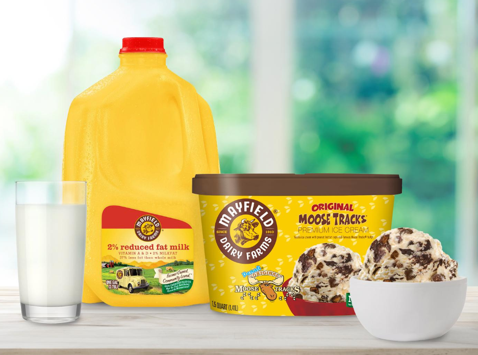 Mayfield Dairy Farms Original Moose Tracks ice cream with 2% reduced fat milk and a glass of milk on a wooden surface