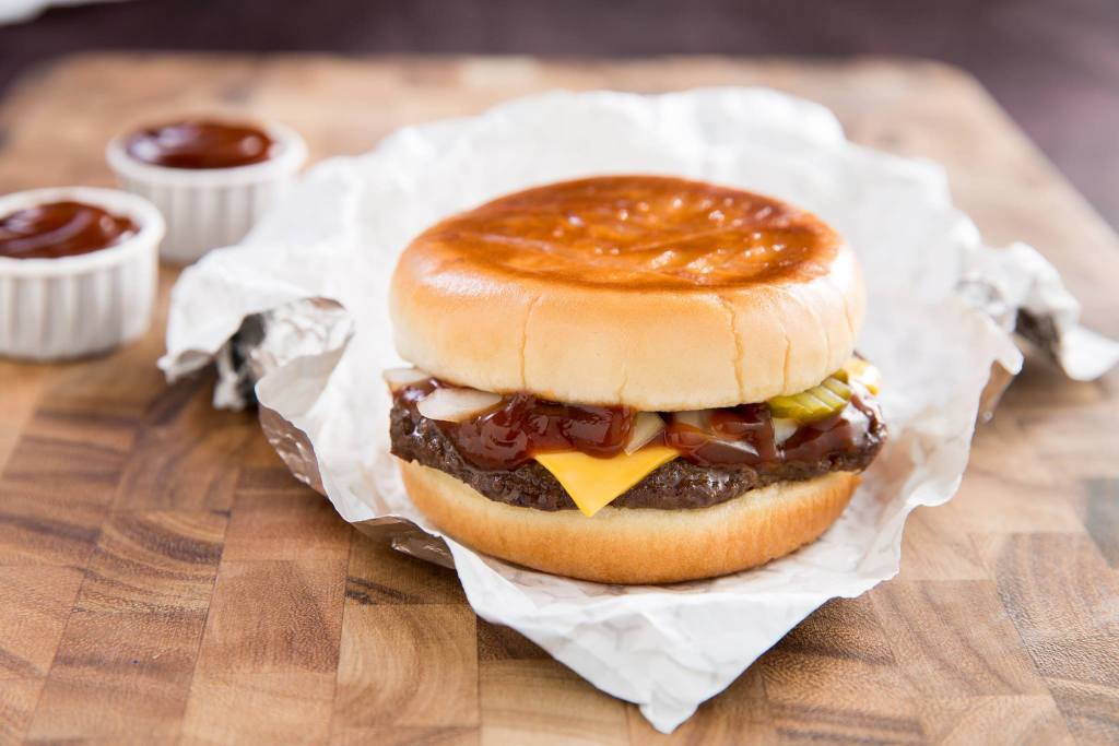 Cheeseburger with Milo’s Hamburger Sauce, pickles, onions, and melted cheese on a toasted bun