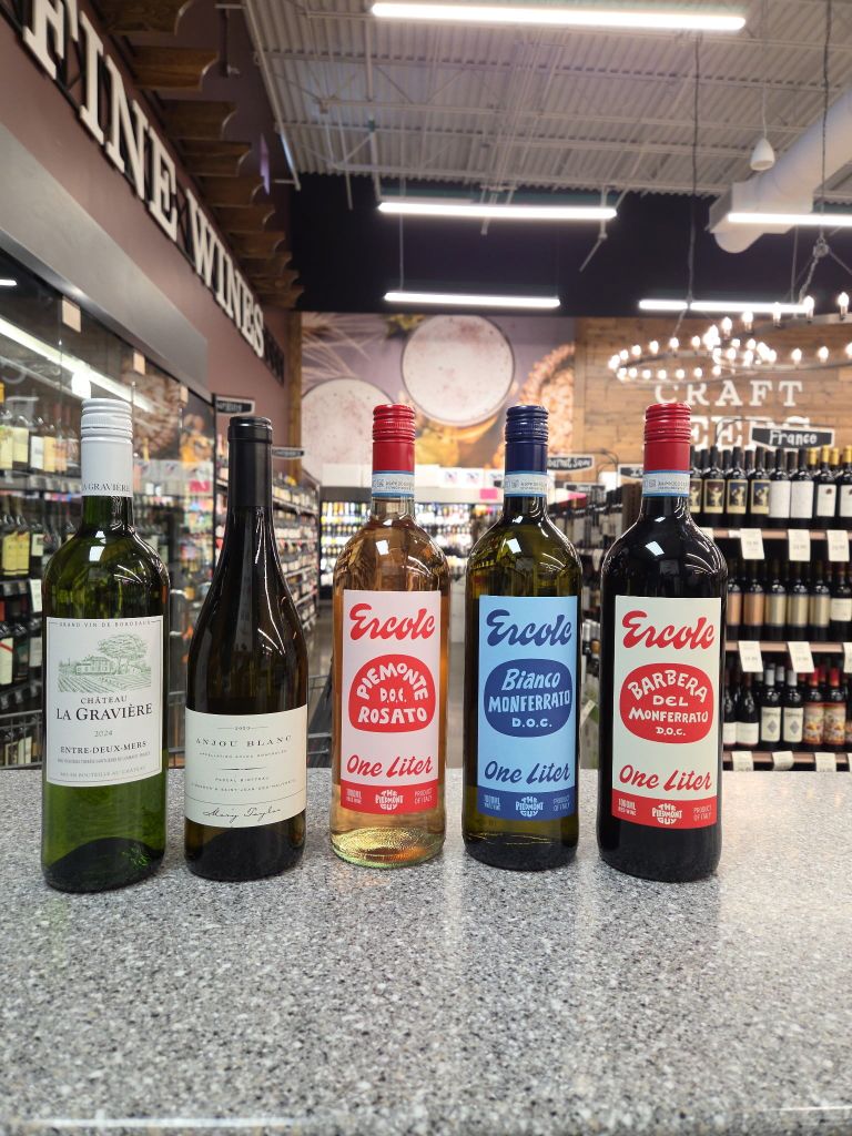 Assorted wine bottles including rosé white and red varieties displayed on a counter inside a Piggly Wiggly Birmingham store