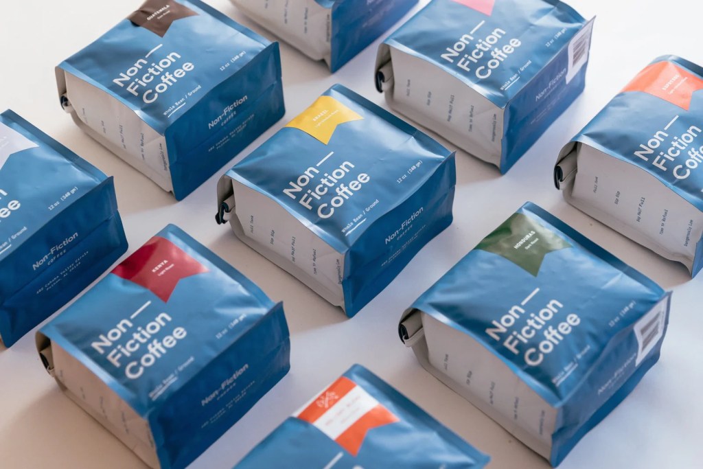 Assorted bags of Non-Fiction Coffee specialty coffee displayed on a table, featuring single-origin and blended coffee varieties roasted in Birmingham, Alabama.
