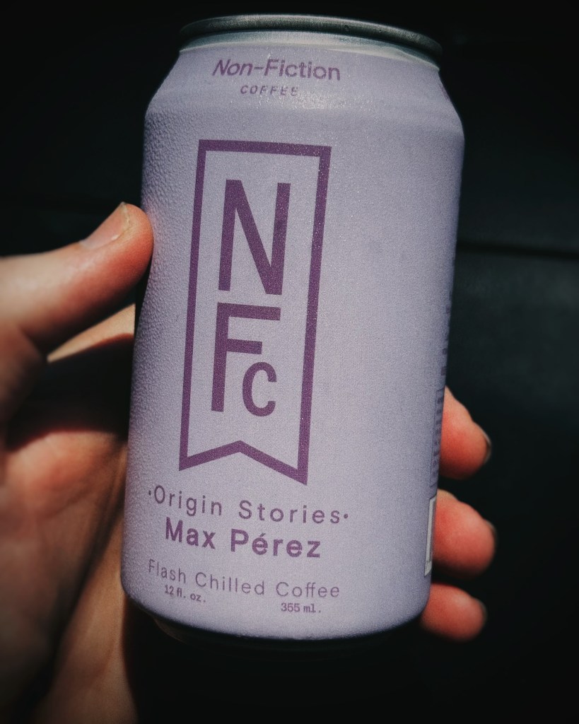 Hand holding a can of Non-Fiction Coffee Max Perez Origin Stories Flash Chilled Coffee, a ready-to-drink specialty coffee beverage available at Piggly Wiggly Birmingham.